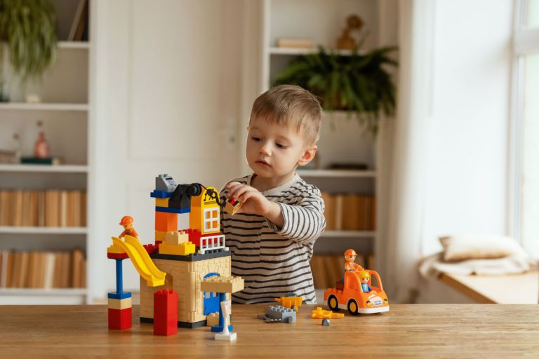 Enfant qui joue avec des jeux de construction colores